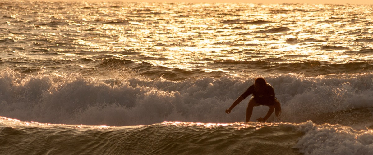 Sunset while surfing the waves. Idyllic..